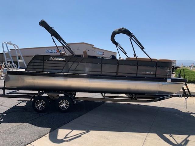 Slide: The Image of 2024 Landau Atlantis 250 Swingback Rear Lounge Tri-Log pontoon boat on trailer. - 6