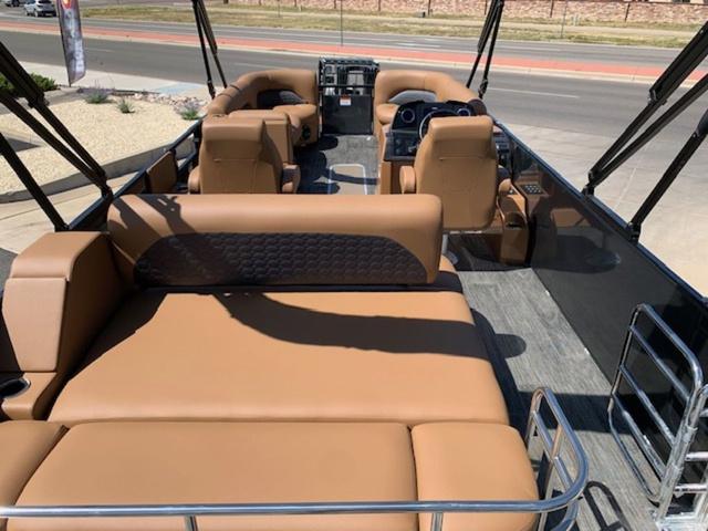 Slide: The Image of 2024 Landau Atlantis 250 Swingback Rear Lounge Tri-Log boat interior with tan seating. - 9