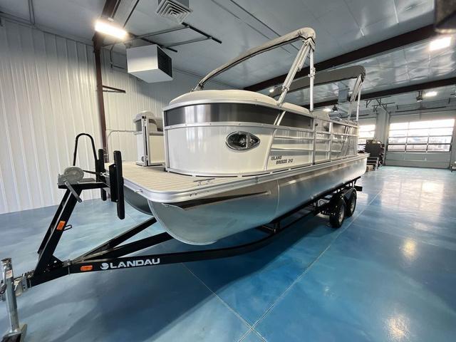 Slide: The Image of 2024 Landau Island Breeze 212 Sport Rear Lounge Tri-Log pontoon boat in showroom. - 1