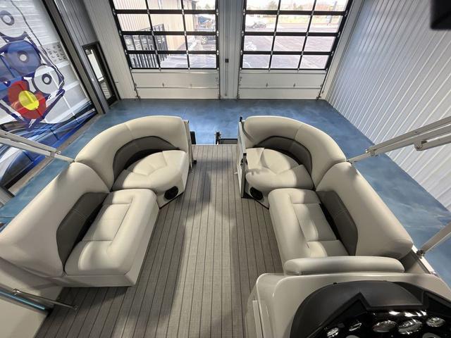 Slide: The Image of 2024 Landau Island Breeze 212 Sport Rear Lounge Tri-Log interior with plush seating. - 11
