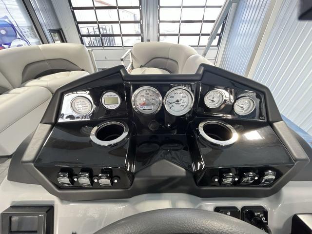 Slide: The Image of 2024 Landau Island Breeze 212 Sport Rear Lounge Tri-Log dashboard with gauges and controls. - 15