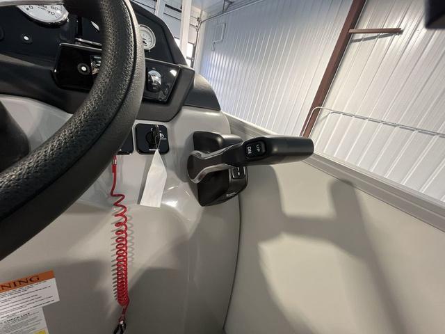 Slide: The Image of 2024 Landau Island Breeze 212 Sport Rear Lounge Tri-Log boat control panel and throttle. - 16