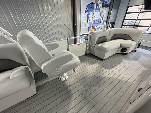 Slide: The Image of 2024 Landau Island Breeze 212 Sport Rear Lounge Tri-Log interior with plush seating. - 17