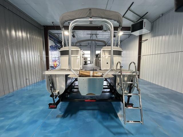Slide: The Image of 2024 Landau Island Breeze 212 Sport Rear Lounge Tri-Log pontoon boat in storage facility. - 4