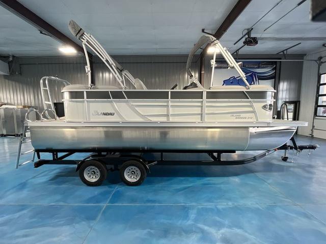Slide: The Image of 2024 Landau Island Breeze 212 Sport Rear Lounge Tri-Log pontoon boat in showroom. - 6