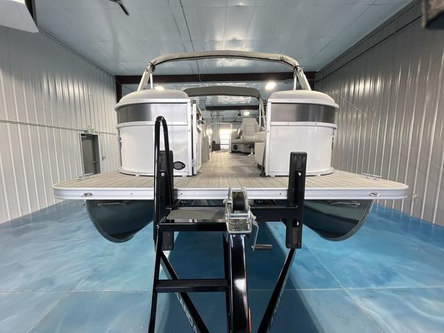Slide: The Image of 2024 Landau Island Breeze 212 Sport Rear Lounge Tri-Log pontoon boat in a showroom. - 8