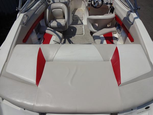 Slide: The Image of Interior of a 2007 Larson 206 Senza boat with red and white seating. - 6
