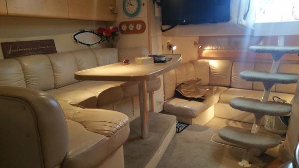 Slide: The Image of Luxurious interior of a 2003 Larson 330 Cabrio boat with beige leather seating. - 11