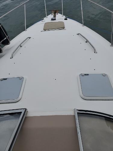 Slide: The Image of 2003 Larson 330 CABRIO boat deck with hatches and railing. - 2