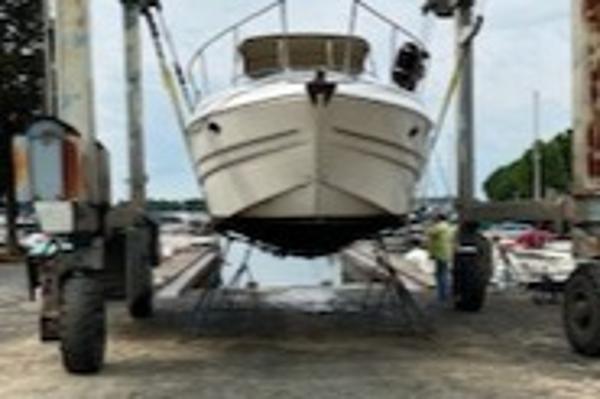 Slide: The Image of 2003 Larson 330 Cabrio boat on lift at marina. - 27