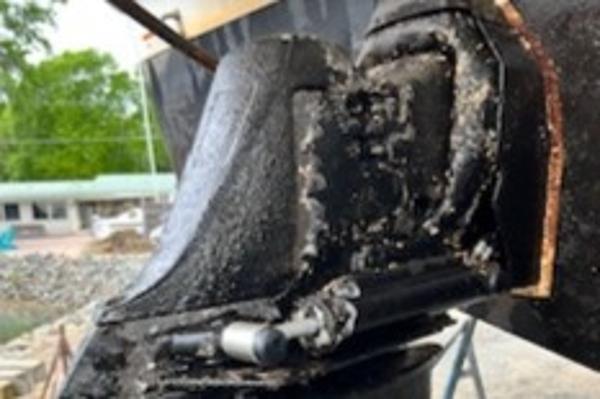 Slide: The Image of Close-up of a 2003 Larson 330 CABRIO boat's engine component, showing wear and corrosion. - 31
