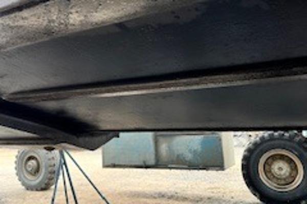 Slide: The Image of Underside view of a 2003 Larson 330 CABRIO boat on a trailer. - 35