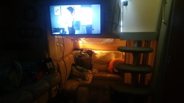 Slide: The Image of Interior of 2003 Larson 330 Cabrio boat with TV, couch, and steps. - 6