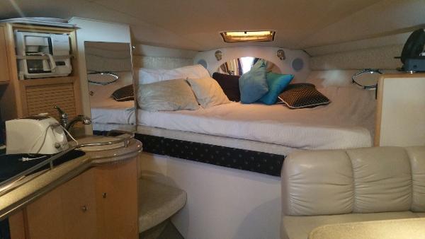 Slide: The Image of Interior of 2003 Larson 330 Cabrio boat with cozy bed and kitchenette. - 8