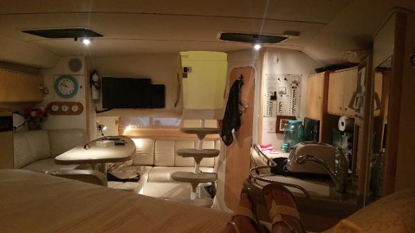 Slide: The Image of Interior of 2003 Larson 330 CABRIO boat with cozy seating and modern amenities. - 9