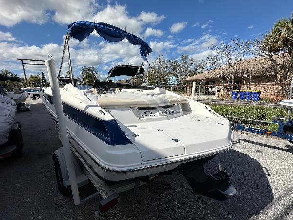 Slide: The Image of 2006 Larson LXi 208 boat on trailer under blue sky. - 2