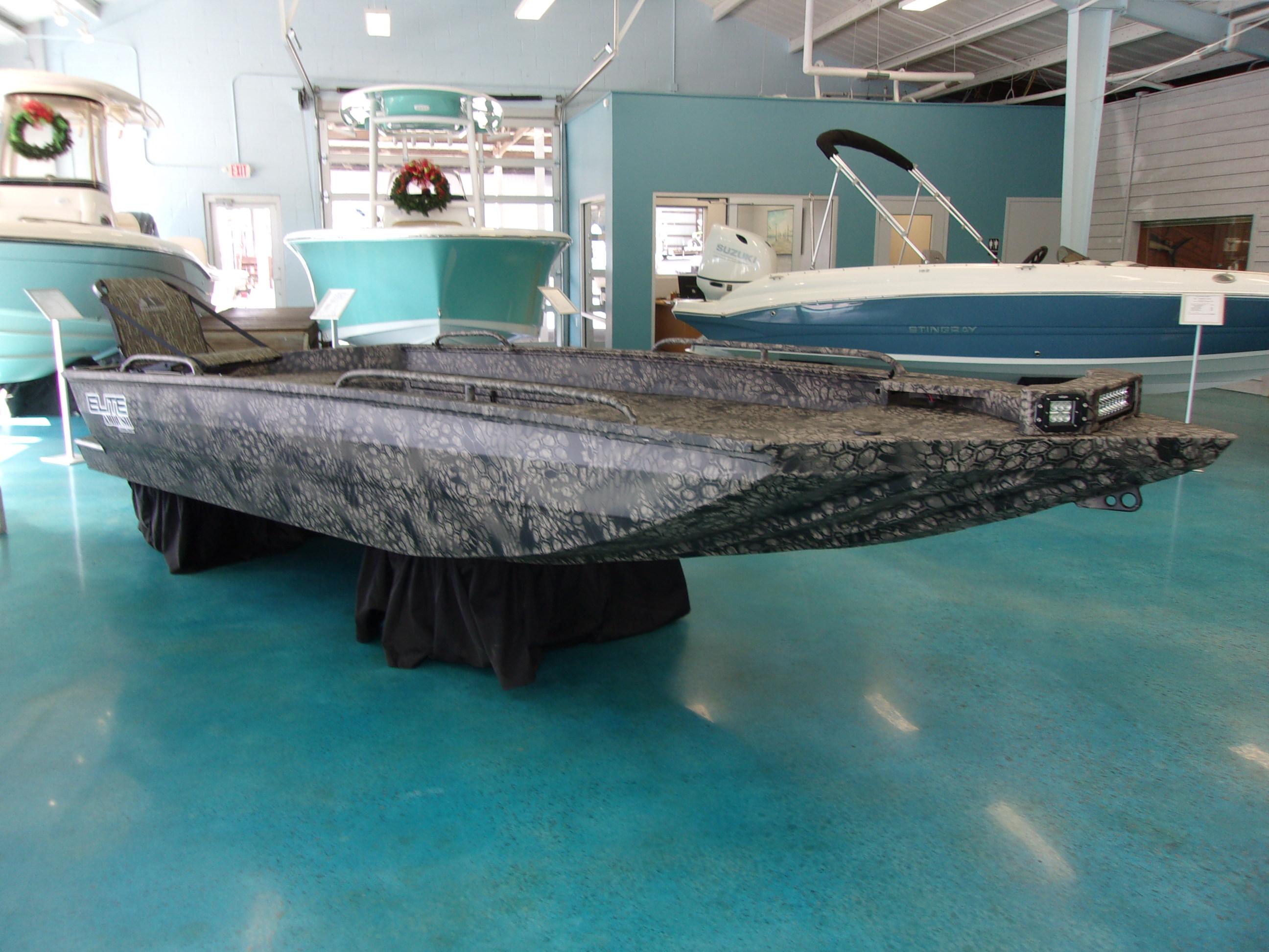 Slide: The Image of 2023 Legendcraft Boats Ambush Elite 1656 on display in a showroom. - 1