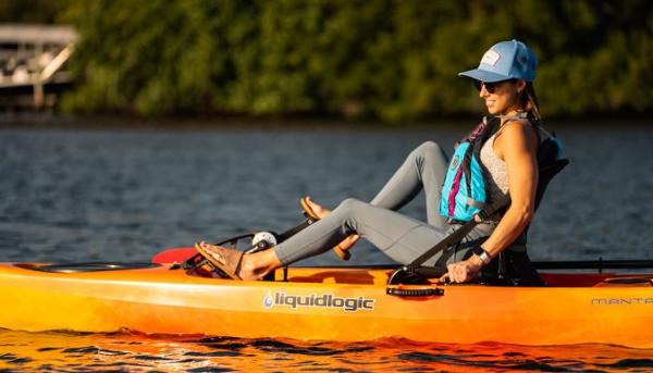 Slide: The Image of Woman kayaking on Liquidlogic Manta Ray Propel 12, 2023 model, in a serene lake. - 6