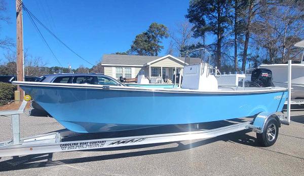 Slide: The Image of 2024 Lookout Skiff Bay 19 boat on a trailer in a residential area. - 0