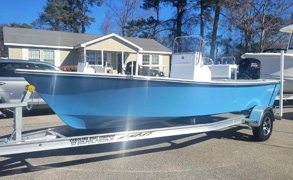 Slide: The Image of 2024 Lookout Skiff Bay 19 boat on a trailer in a residential area. - 1