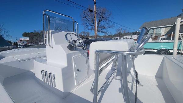 Slide: The Image of 2024 Lookout Skiff Bay 19 center console boat with steering wheel and seating. - 10