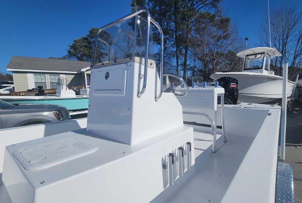 Slide: The Image of 2024 Lookout Skiff Bay 19 boat with center console in a marina. - 14