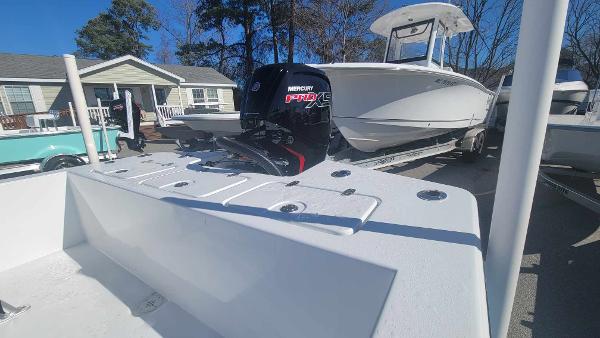 Slide: The Image of 2024 Lookout Skiff Bay 19 boat with Mercury Pro XS engine in a marina. - 15
