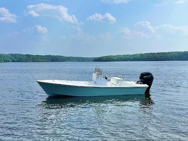 Slide: The Image of 2024 Lookout Skiff Bay 19 boat on a serene lake. - 16