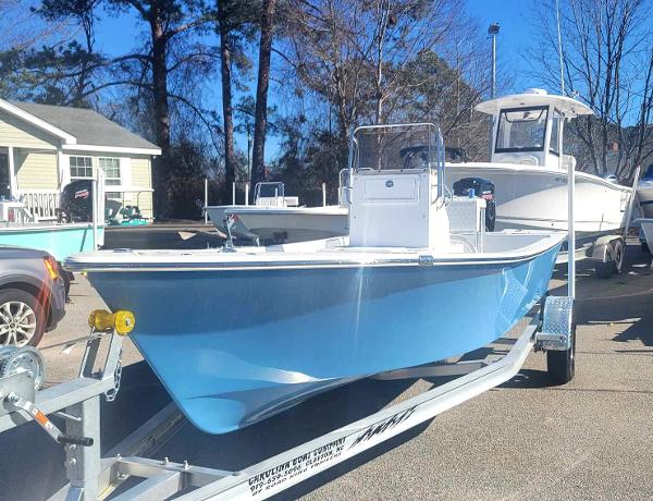 Slide: The Image of 2024 Lookout Skiff Bay 19 boat on trailer in outdoor setting. - 2