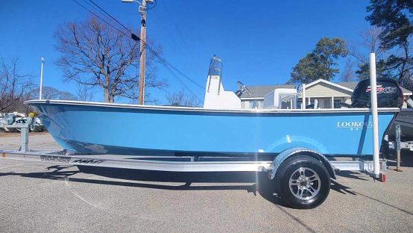Slide: The Image of 2024 Lookout Skiff Bay 19 boat in light blue on a trailer. - 3
