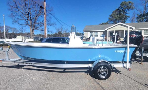 Slide: The Image of 2024 Lookout Skiff Bay 19 boat on trailer, blue hull, parked outdoors. - 5