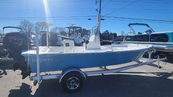 Slide: The Image of 2024 Lookout Skiff Bay 19 boat on trailer, side view in a dealership lot. - 6