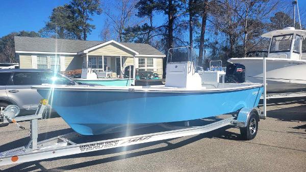 Slide: The Image of 2024 Lookout Skiff Bay 19 boat on a trailer in a residential area. - 7
