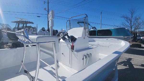 Slide: The Image of 2024 Lookout Skiff Bay 19 boat, center console, white exterior, docked outdoors. - 9