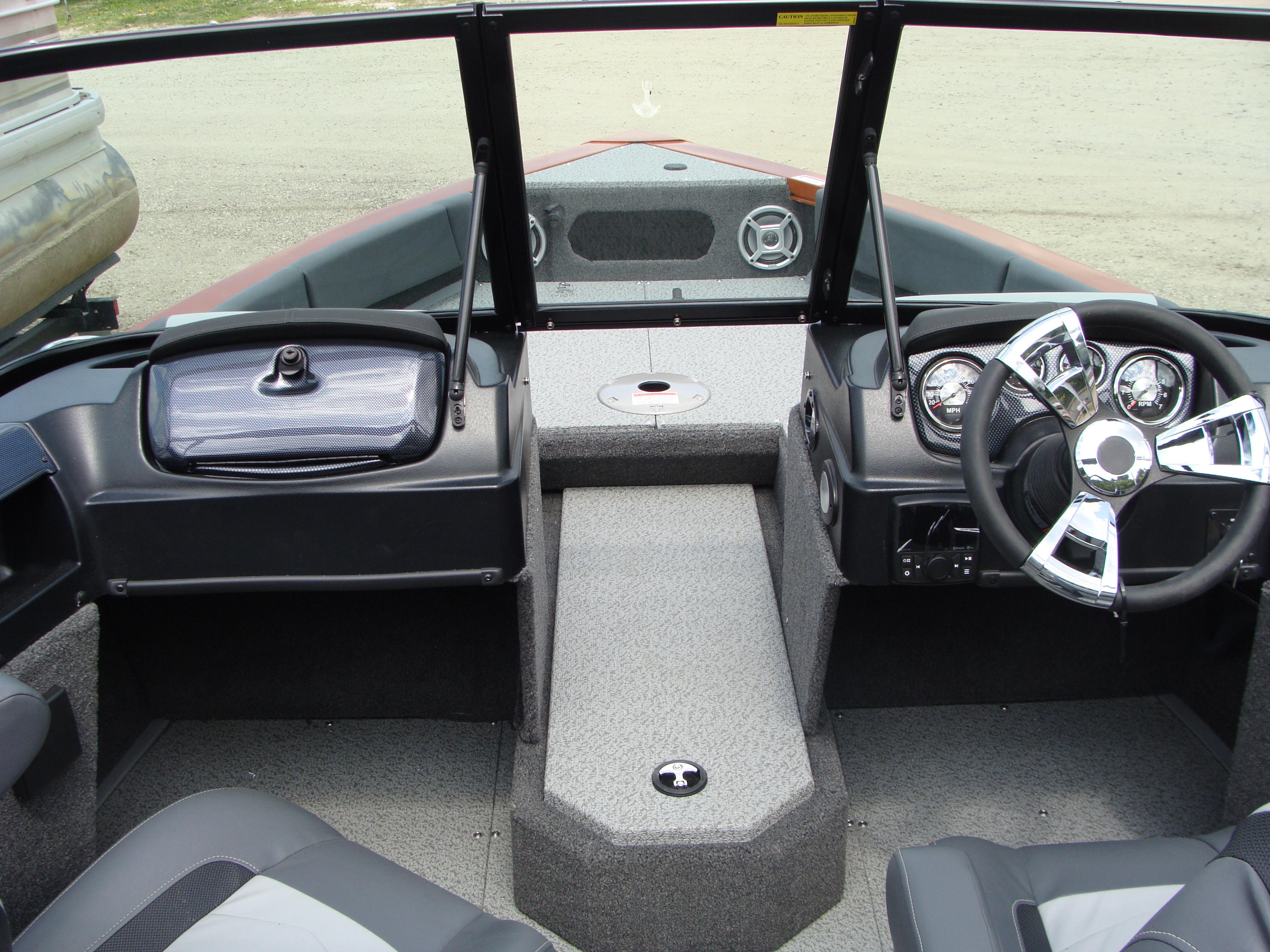 Slide: The Image of 2023 Lowe FS 1900 boat interior with steering wheel and dashboard. - 8
