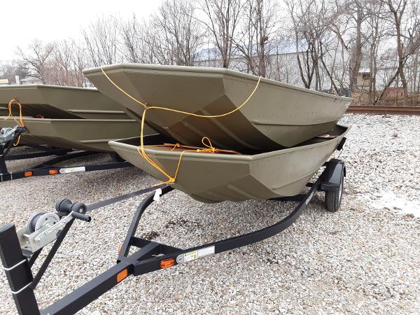 Slide: The Image of 2024 Lowe Jon L1448 boats on trailer in outdoor setting. - 1