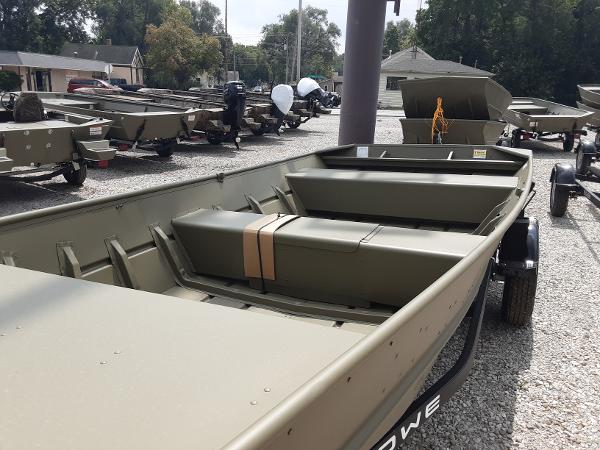 Slide: The Image of 2024 Lowe Jon L1648M boat on display in a dealership lot. - 2