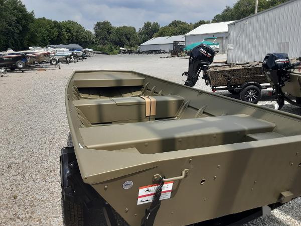 Slide: The Image of 2024 Lowe Jon L1648M boat on gravel lot with other boats in background. - 3