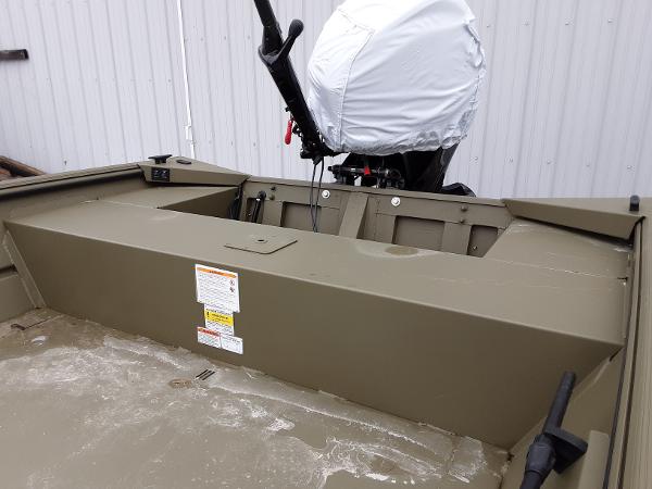 Slide: The Image of 2024 Lowe Roughneck 1660 boat interior with covered outboard motor. - 3