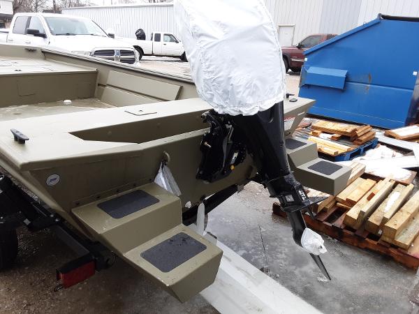Slide: The Image of 2024 Lowe Roughneck 1660 boat with outboard motor, parked outdoors. - 4