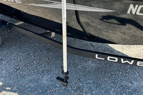 Slide: The Image of 2022 Lowe Skorpion 16 boat on gravel surface. - 25