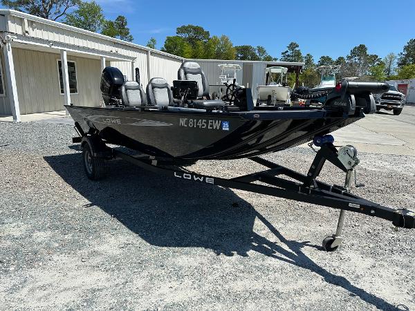 Slide: The Image of 2022 Lowe Skorpion 16 fishing boat on trailer in outdoor setting. - 6