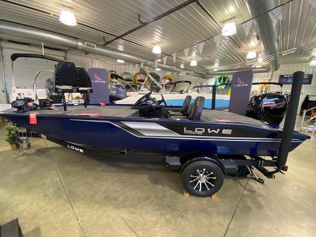 Slide: The Image of 2023 Lowe Stinger 188 Pro Series boat displayed indoors, showcasing sleek design and modern features. - 0
