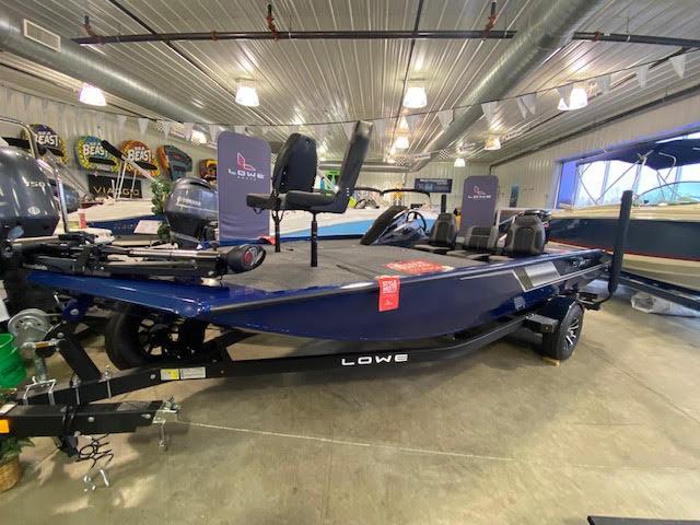 Slide: The Image of 2023 Lowe Stinger 188 Pro Series boat displayed indoors, featuring a sleek design and modern equipment. - 1