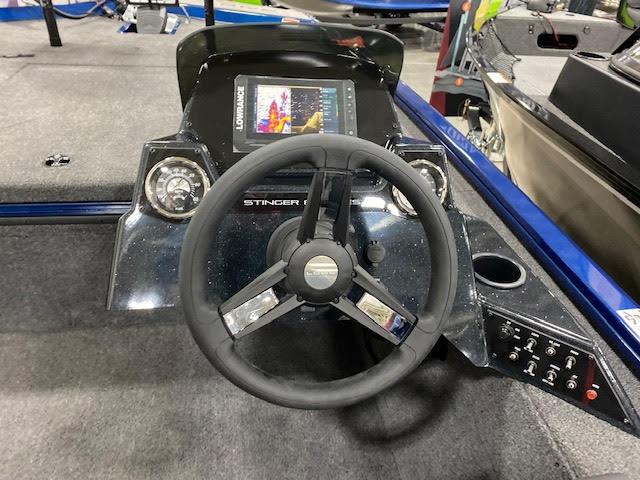 Slide: The Image of 2023 Lowe Stinger 188 Pro Series boat dashboard with steering wheel and control panel. - 14
