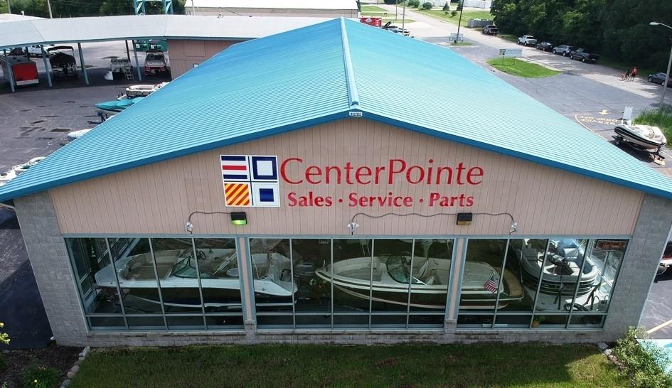 Slide: The Image of CenterPointe building with boats, including 2023 Lowe Stinger 188 Pro Series, under a blue roof. - 15