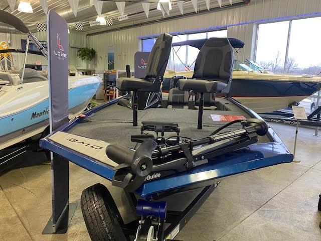 Slide: The Image of 2023 Lowe Stinger 188 Pro Series boat displayed in showroom with dual seats and motor. - 4