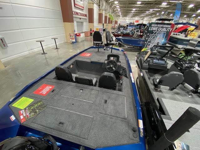 Slide: The Image of 2023 Lowe Stinger 188 Pro Series boat on display in a showroom. - 5