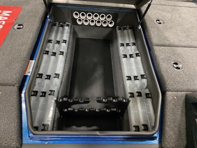 Slide: The Image of 2023 Lowe Stinger 188 Pro Series boat storage compartment with organized tackle boxes and rod holders. - 8