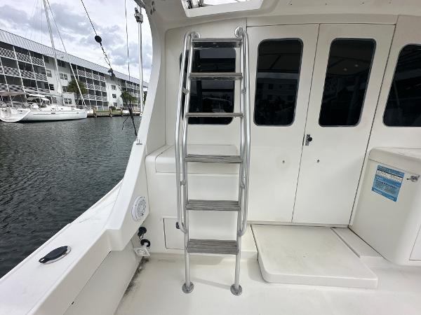 Slide: The Image of 1993 Luhrs 320 Tournament boat with ladder and cabin doors, docked at marina. - 10
